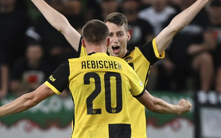 Young Boys' Sandro Lauper, right, and Michel Aebischer celebrate their victory after the Champions League Play-off second leg soccer match between Ferencvaros TC and BSC Young Boys of Switzerland at t ...