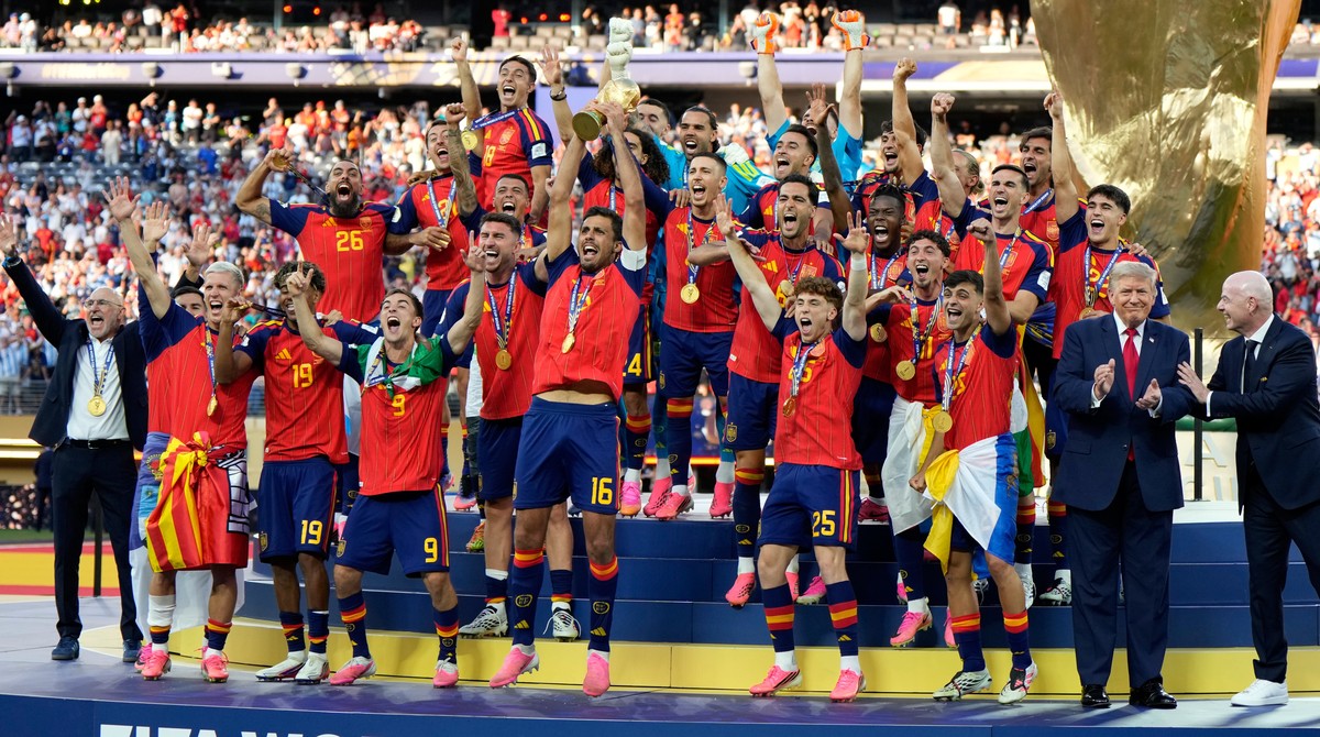 President Donald J. Trump and FIFA President Gianni Infantino, right, applaud as Spain's team captain Rodri lifts the trophy after winning the World Cup final soccer match between Spain and Argen ...