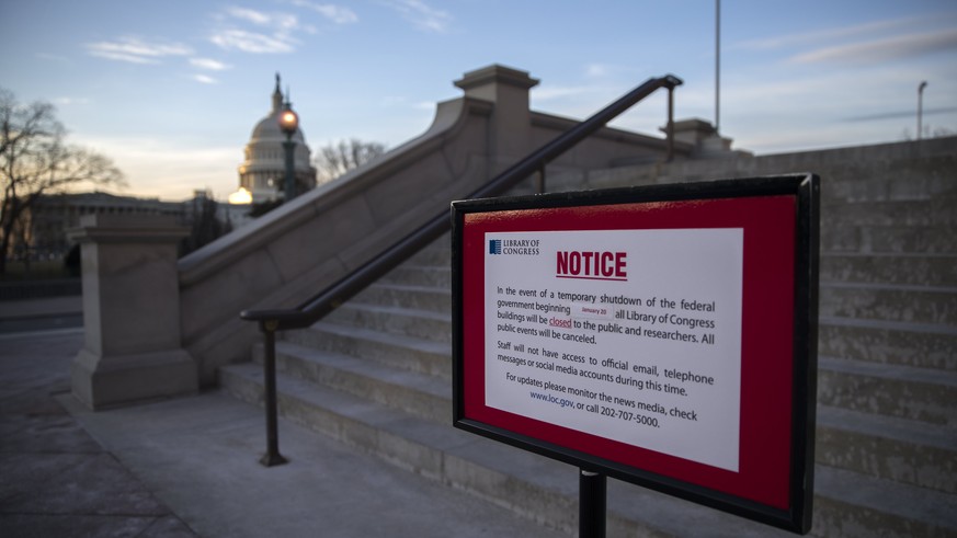 epa06459042 A closed sign in front of the Library of Congress as the Senate continues work on ending the government shutdown in the US Capitol in Washington, DC, USA, 20 January 2018. Negotiations con ...