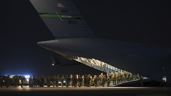 August 17, 2021, Ali Al Salem Air Base, Kuwait: In a handout photo provided by the US Air Force, U.S. Army soldiers board a C-17 Globemaster III aircraft prior to departure for Hamid Karzai Internatio ...