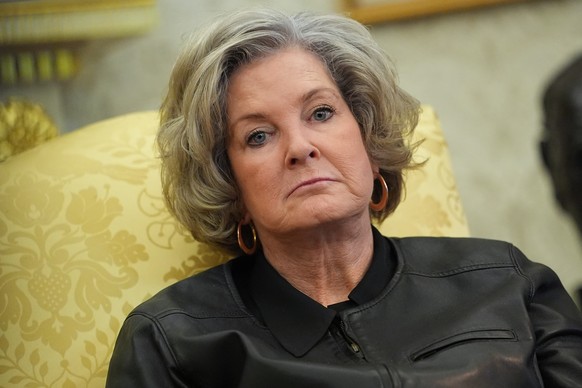 White House chief of staff Susie Wiles listens as President Donald Trump speaks to reporters after signing an executive order reclassifying marijuana as a less dangerous drug in the Oval Office of the ...