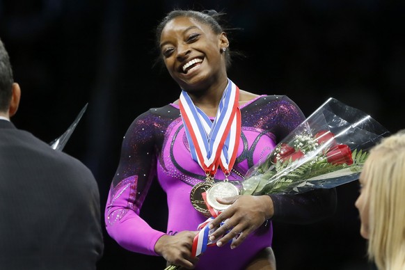 Simone Biles smiles after getting her gold medal at the gymnastics U.S. Championships, Saturday, Aug. 23, 2014, in Pittsburgh. Biles captured her second straight national title on Saturday night. (AP  ...