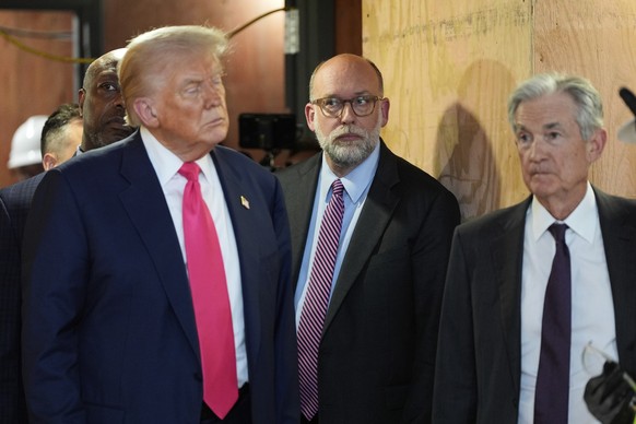 Russell Vought, director of the Office of Management and Budget, center, with President Donald Trump, left and Federal Reserve Chairman Jerome Powell, visit the Federal Reserve, Thursday, July 24, 202 ...