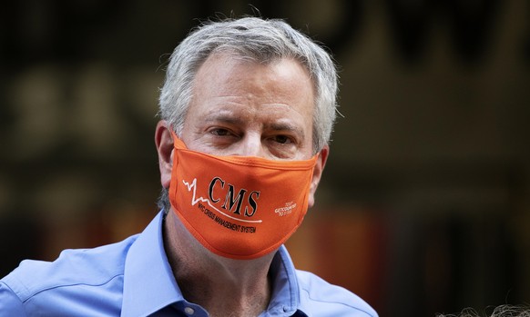 New York Mayor Bill de Blasio wears a mask while painting Black Lives Matter on Fifth Avenue in front of Trump Tower, Thursday, July 9, 2020, in New York. (AP Photo/Mark Lennihan)