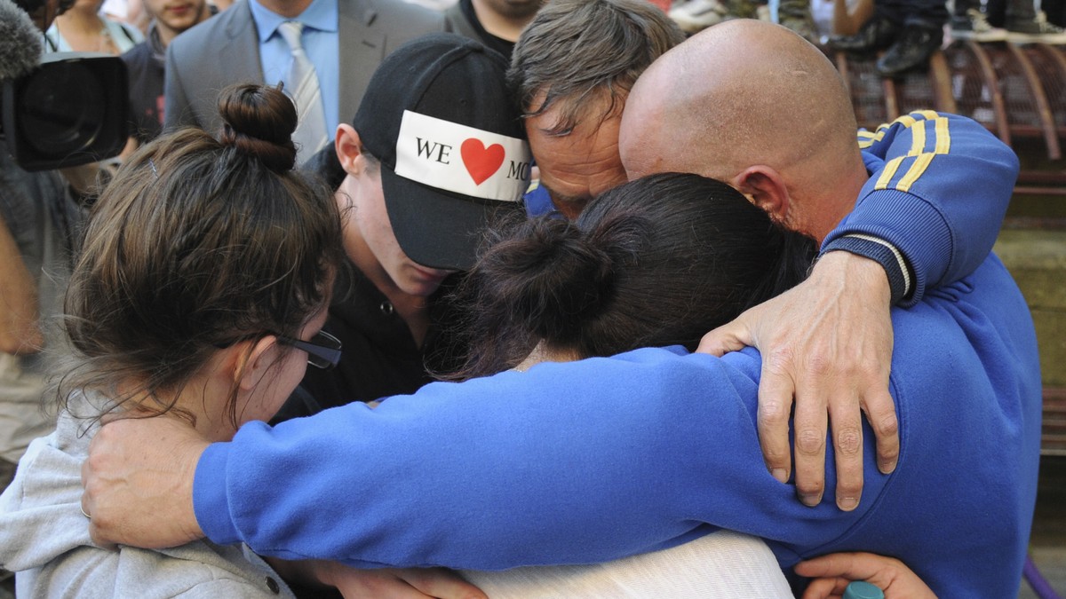 Olivia Campbell's mother Charlotte Campbell, and stepfather Paul Hodgson, gesture with friends as they pay tribute to her and the other victims of the explosion outside Manchester Arena, at St An ...