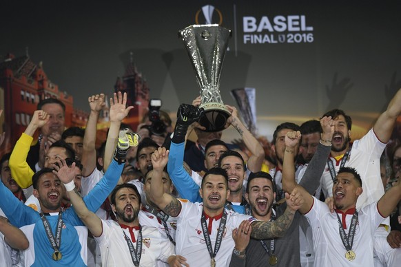 Sevilla players celebrate with the trophy after winning the UEFA Europa League final between England's Liverpool FC and Spain's Sevilla Futbol Club at the St. Jakob-Park stadium in Basel, Sw ...