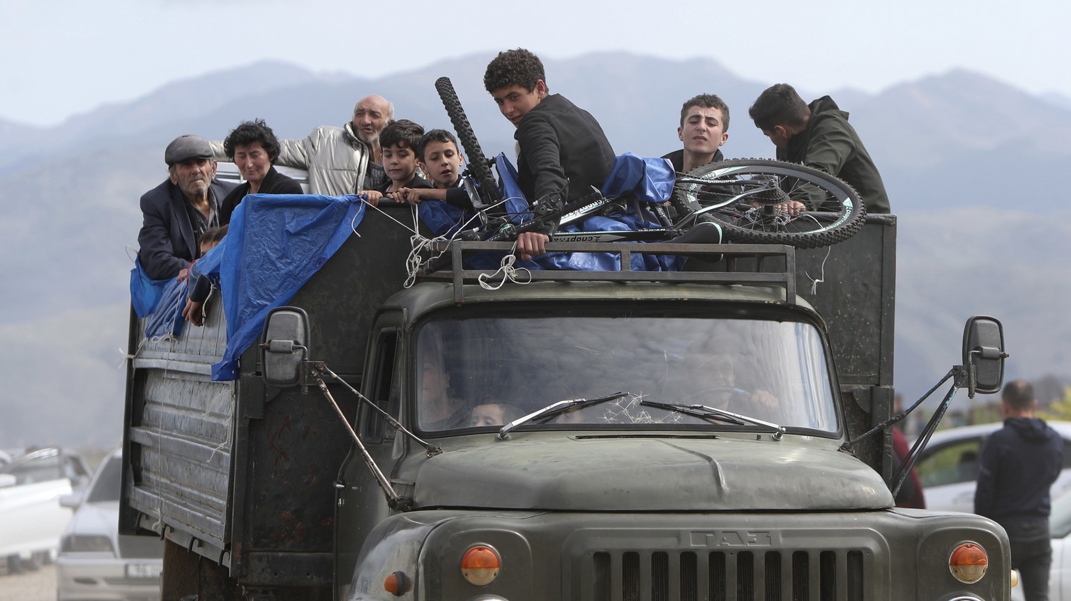 FILE - Ethnic Armenians from Nagorno-Karabakh ride a truck on their way to Kornidzor in Syunik region, Armenia, Sept. 26, 2023. Thousands of Nagorno-Karabakh residents are fleeing their homes after Az ...