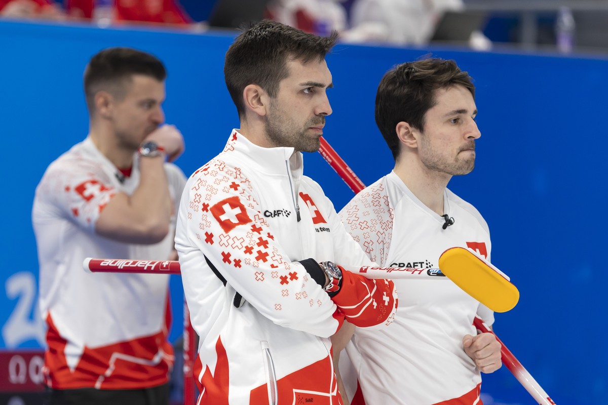 Switzerland's Skip Peter de Cruz, center, and his teammates Valentin Tanner, left, and Benoit Schwarz, right, observe the rocks, during the men's Round Robin #1 game between Norway and Switz ...