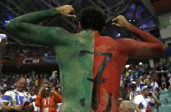 A supporter with his body painted in Portuguese colors and Cristiano Ronaldo&#039;s number 7 poses as he waits for start of the round of 16 match between Uruguay and Portugal at the 2018 soccer World  ...