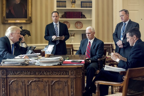 FILE - In this Jan. 28, 2017, file photo, President Donald Trump accompanied by, from second from left, Chief of Staff Reince Priebus, Vice President Mike Pence, White House press secretary Sean Spice ...