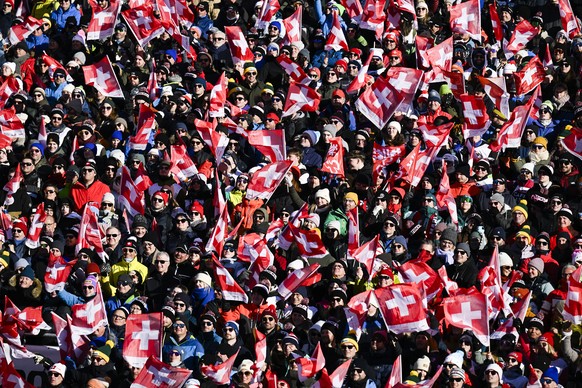 Fans cheer during the second run of the men's Giant Slalom race at the Alpine Skiing FIS Ski World Cup, in Adelboden, Switzerland, Sunday, January 12, 2025. (KEYSTONE/Anthony Anex)