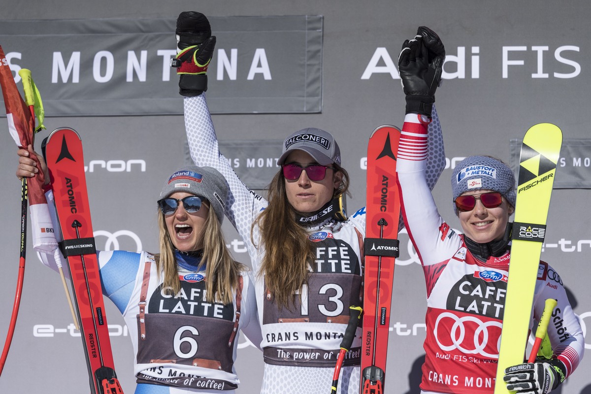 epa07389848 (L-R) Joana Haehlen of Switzerland, Sofia Goggia of Italy and Nicole Schmidhofer of Austria react after the Women's Downhill race of the FIS Alpine Ski World Cup event in Crans-Montan ...