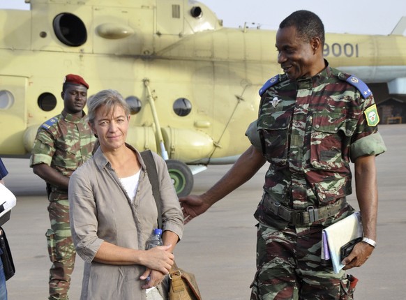 FILE - In this April 24, 2012, file photo, released Swiss hostage Beatrice Stoeckli, left, stands in Ouagadougou, Burkina Faso, following arrival by helicopter from Timbuktu, Mali, after being handed  ...