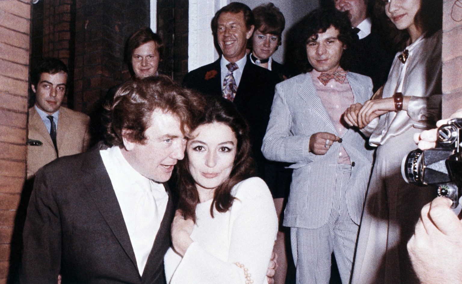 FILE - In this 1970 file photo, British actor Albert Finney embraces his bride, French Actress Anouk Aimee, after their registry office wedding in London. Finney, the Academy Award-nominated star of f ...