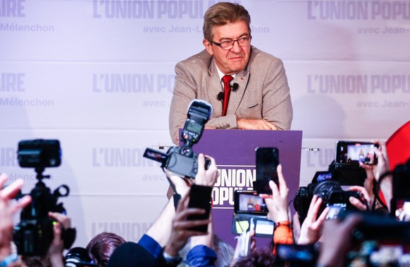 epa09883413 Presidential candidate of the La France Insoumise (LFI) party, Jean-Luc Melenchon (C) delivers a speech after results in the first round of the French presidential elections in Paris, Fran ...