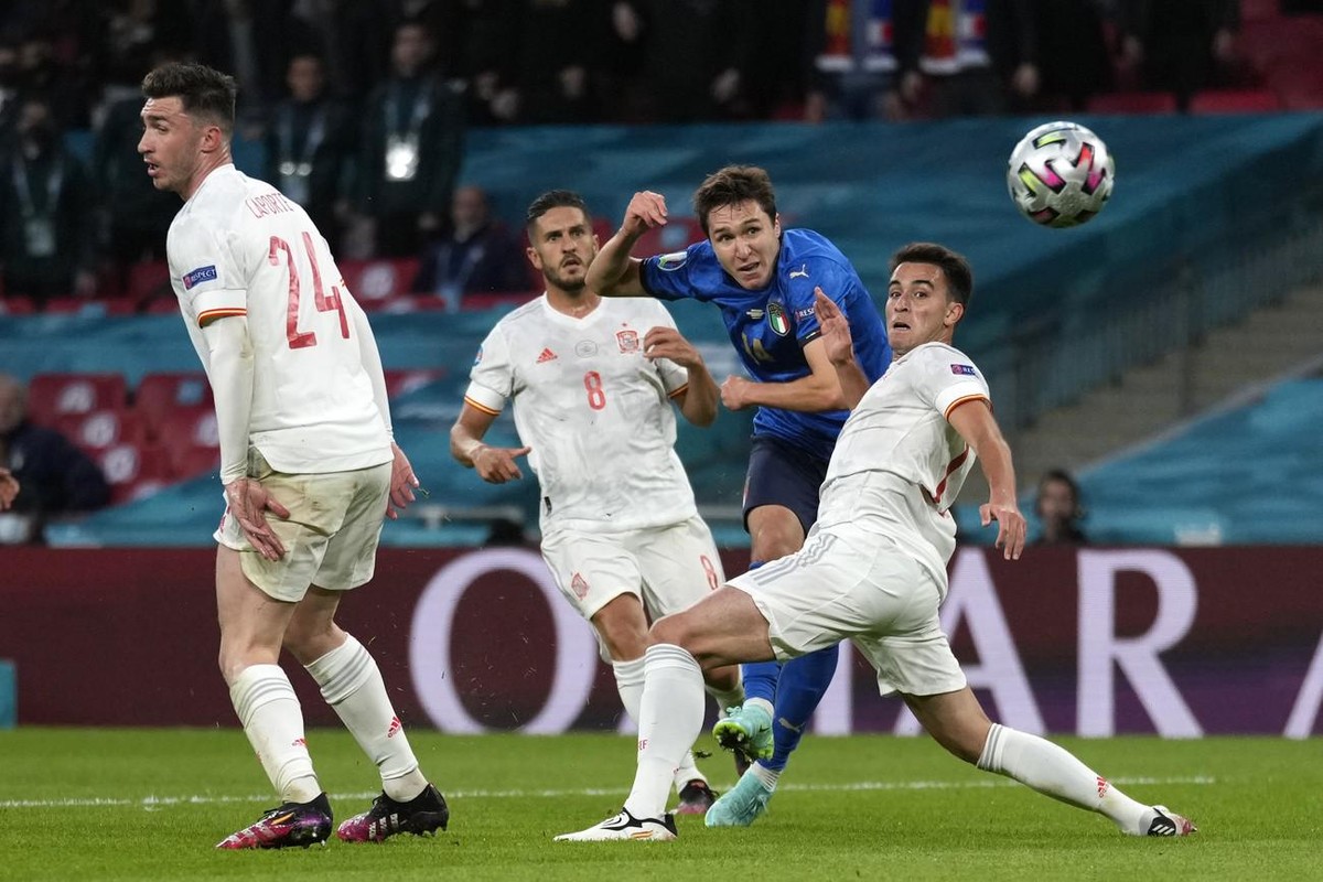 Italy's Federico Chiesa, second right, scores his side's opening goal during the Euro 2020 soccer semifinal match between Italy and Spain at Wembley stadium in London, Tuesday, July 6, 2021. ...