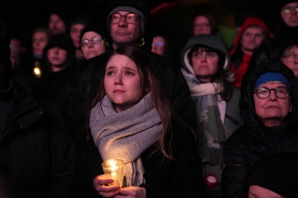 People outside Magdeburg Cathedral follow a memorial service for victims of Friday&#039;s Christmas Market attack, where a car drove into a crowd, in Magdeburg, Germany, Saturday, Dec. 21, 2024. (AP P ...