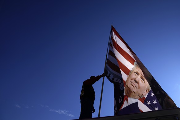 epa08880487 A supporter of US President Donald J. Trump on Freedom Plaza to echo Trump&#039;s baseless claims of voter fraud in the US presidential election, in Washington, DC, USA, 12 December 2020.  ...