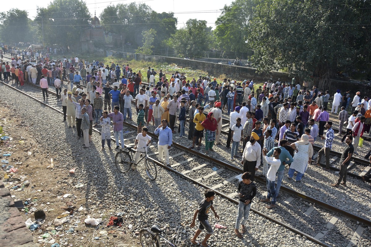 A crowd gathers at the site of Friday's train accident in Amritsar, India, Saturday, Oct. 20, 2018. A speeding train ran over a crowd watching fireworks during a religious festival in northern In ...