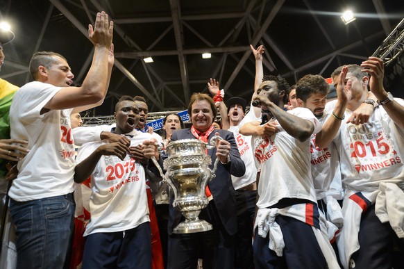 FC Sion players celebrates with FC Sion president Christian Constantin, center with the trophy, on stage in front of their fans after they won the Swiss Cup final soccer match against FC Basel, in Sion, Switzerland, late Sunday, June 7, 2015. (KEYSTONE/Jean-Christophe Bott)