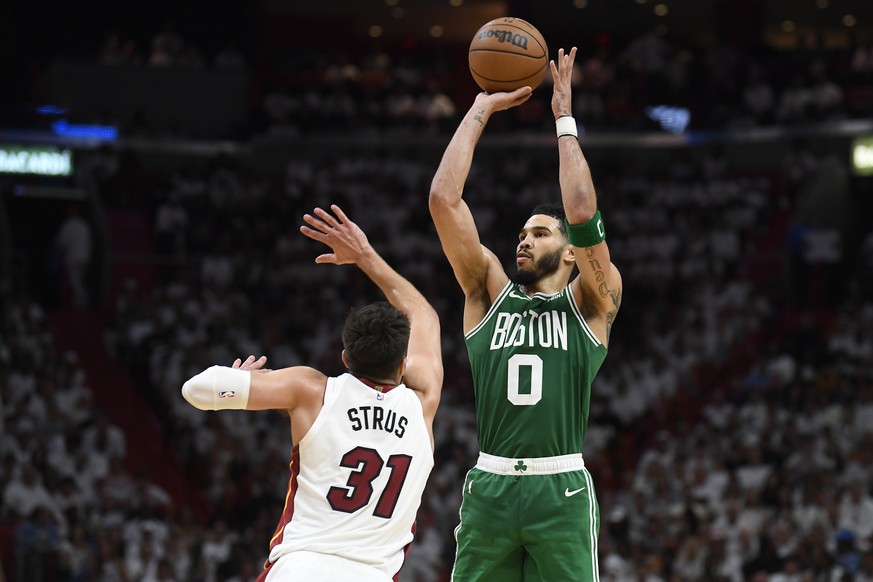 Boston Celtics forward Jayson Tatum (0) hits a shot against Miami Heat guard Max Strus (31) during the second half of Game 6 of the NBA Eastern Conference Finals, Saturday, May 27, 2023,...