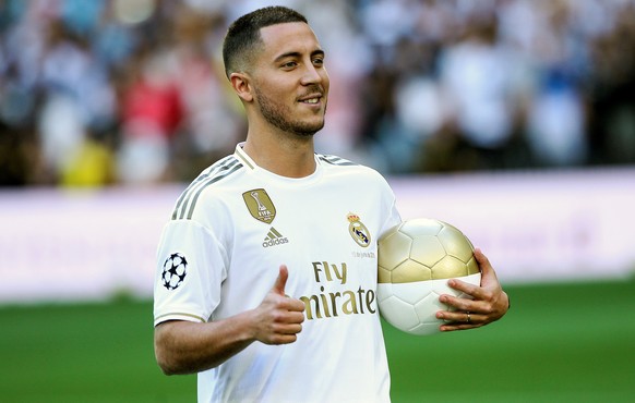 epa07646259 Real Madrid&#039;s new soccer player Eden Hazard poses for the photographers during his presentation at Santiago Bernabeu stadium in Madrid, Spain, 12 June 2019. Belgian Eden Hazard has si ...