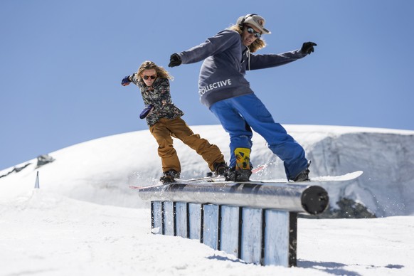 Two snowboarders are riding over a rail in the Snowpark Zermatt on the Theodul glacier on Thursday, August 2, 2018, in Zermatt, Valais, Switzerland. This snowpark in the skiing resort Matterhorn Glaci ...