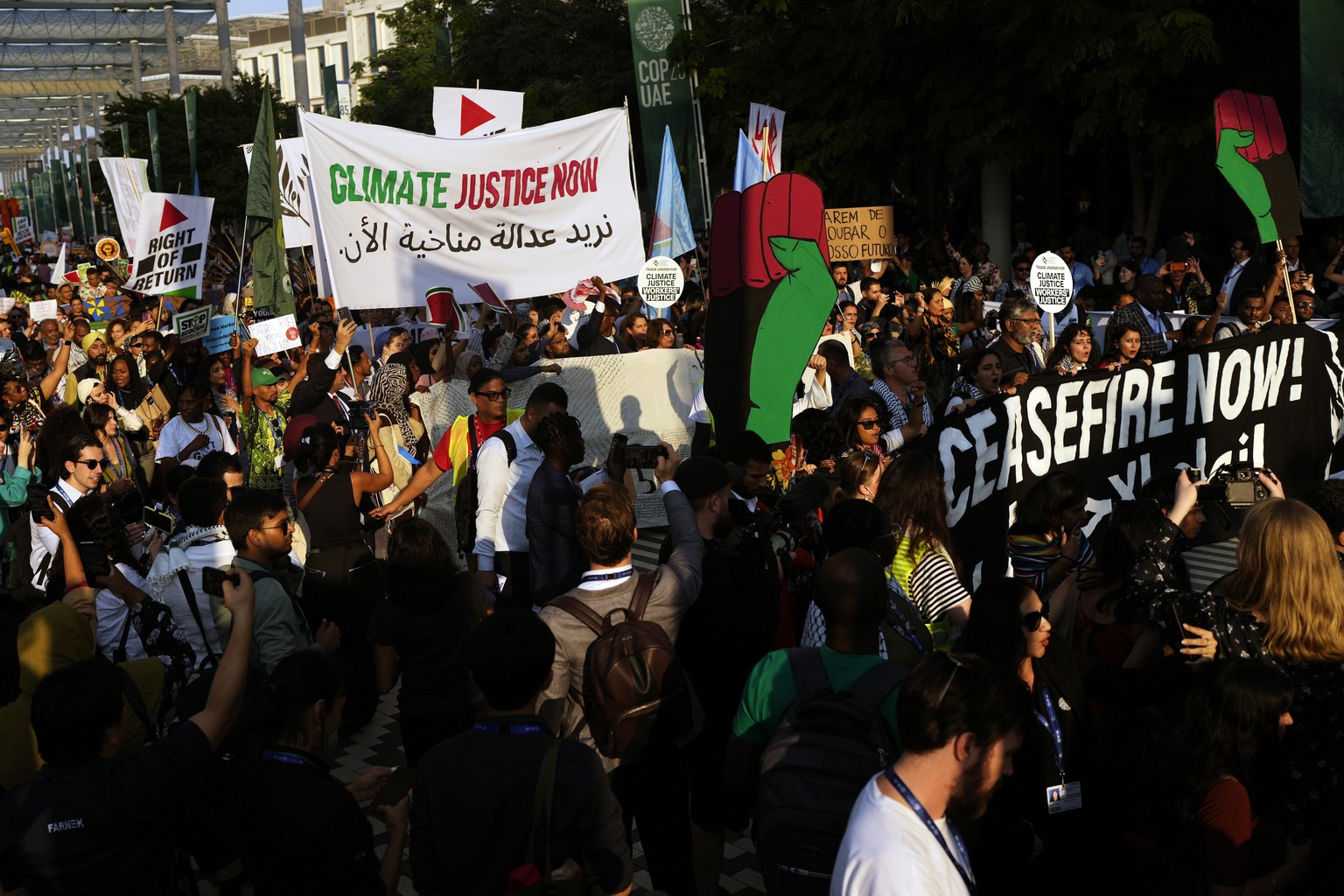 Activists demonstrate for climate justice and a ceasefire in the Israel-Hamas war at the COP28 U.N. Climate Summit, Saturday, Dec. 9, 2023, in Dubai, United Arab Emirates. (AP Photo/Rafiq Maqbool)