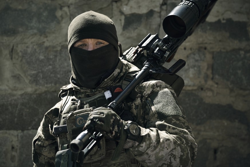 A Ukrainian army sniper looks on near Bakhmut, Donetsk region, Ukraine, Tuesday, May 2, 2023. (AP Photo/Libkos)