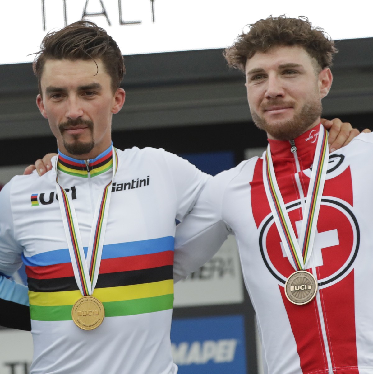 France's Julian Alaphilippe, center, winner of the men's elite event, poses on the podium with second placed Belgium's Wout van Aert, left, and third placed Switzerland's Marc Hirs ...