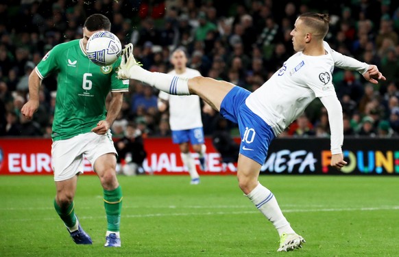 epa10917785 Alan Browne (L) of Ireland in action against Dimtris Pelkas of Greece during the UEFA EURO 2024 group B qualification round match between Ireland and Greece in Dublin, Ireland, 13 October  ...