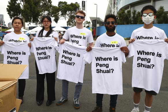 FILE - Supporters of Chinese tennis player Peng Shuai hold up T-shirts ahead of the women&#039;s final at the Australian Open tennis championships in Melbourne, Australia, Saturday, Jan. 29, 2022. The ...