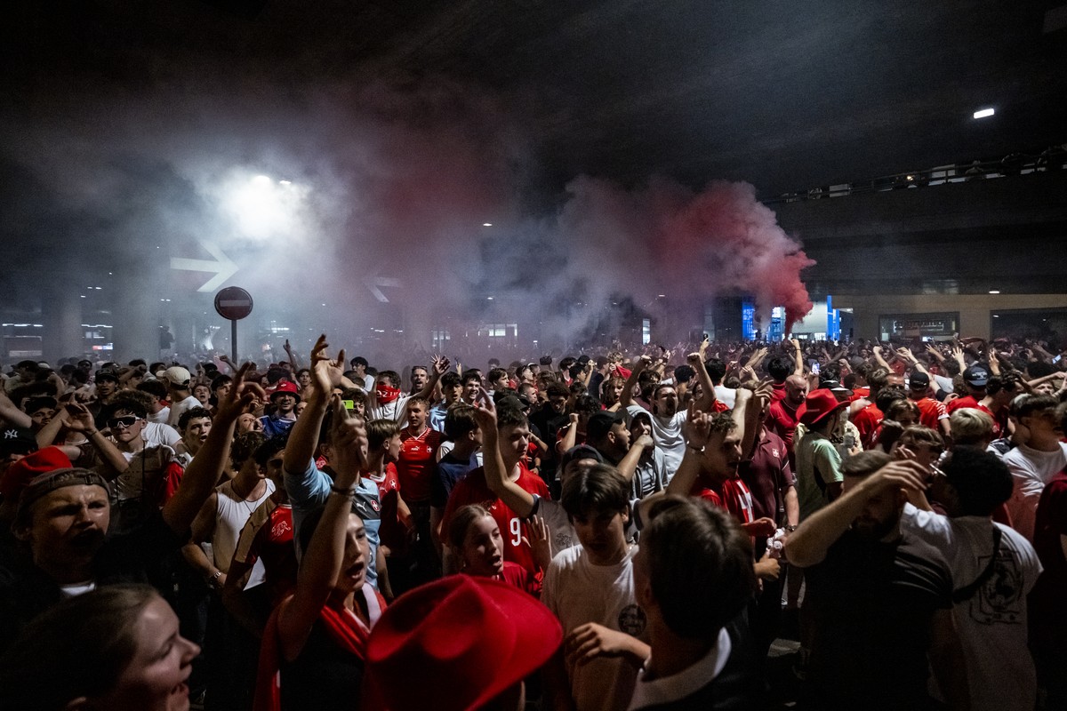 Fans of team Switzerland celebrate as they gather on the streets arround the trainstation Hardbruecke after Switzerland won the 2026 FIFA World Cup soccer round of 16 soccer match between Switzerland  ...