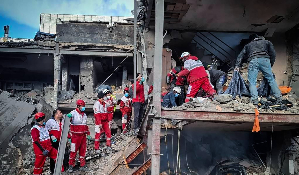Members of Iranian rescue teams search through the rubble for victims after a building was struck by U.S.-Israeli airstrikes in Tehran, Iran on Friday, April 3, 2026. IRN2026040409 IranianxRedxCrescen ...