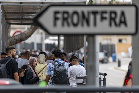 epa13145831 People cross the border as Spain reopens borders with Morocco, in the Spanish enclave of Melilla, 01 August 2026. Violent clashes occurred along the border perimeter for two days as migran ...