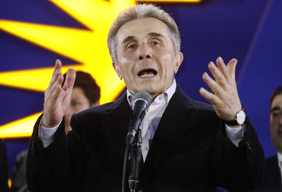 epa11685500 Founder of the Georgian Dream party and oligarch Bidzina Ivanishvili (C) speaks after exit poll results announcement in parliamentary elections, during celebrations at the Georgian Dream p ...