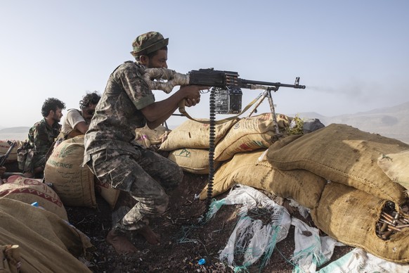 FILE - A Yemeni fighter backed by the Saudi-led coalition fires his weapon during clashes with Houthi rebels on the Kassara frontline near Marib, Yemen, June 20, 2021. Since the longest ceasefire betw ...