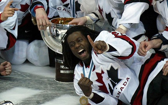 Canada&#039;s hockey players celebrate the winning of the gold medal at the Ice Hockey World Championship in Helsinki, Finland, Sunday, May 11, 2003. Canada defeated Sweden in the final 3-2 with an ov ...