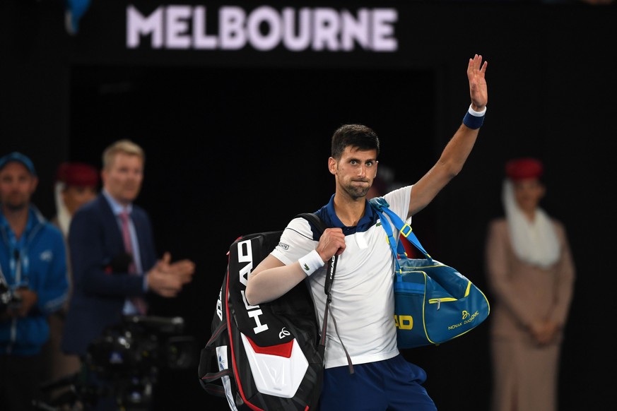 epa06464524 Novak Djokovic of Serbia reacts after being defeated by Hyeon Chung of of South Korea during round four on day eight of the Australian Open tennis tournament, in Melbourne, Victoria, Austr ...