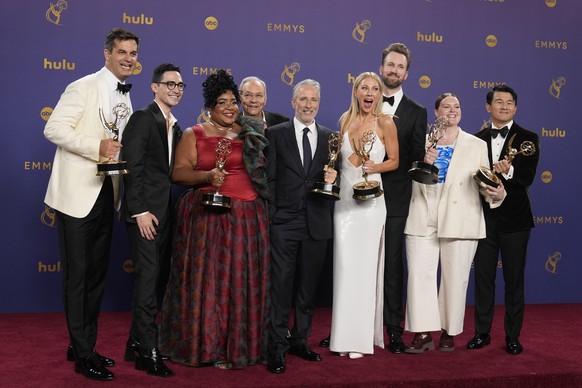 Michael Kosta, from left, Troy Iwata, Dulce Sloan, Lewis Black, Jon Stewart, Desi Lydic, Jordan Klepper, Grace Kuhlenschmidt and Ronny Chieng pose in the press room with the award for outstanding outs ...