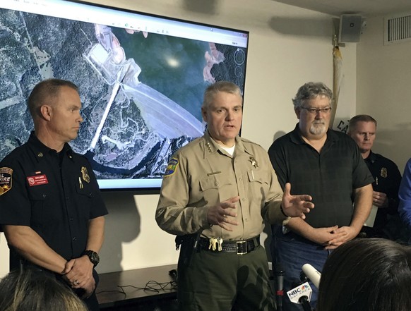 Butte County Sheriff Kory Honea, center, speaks during a news conference in Oroville, Calif., Monday, Feb. 13, 2017. Honea said nearly 200,000 people who were ordered to leave their homes out of fear  ...