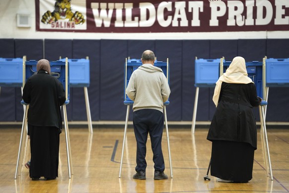 Voters fill out their ballot for the Michigan primary election in Dearborn, Mich., Tuesday, Feb. 27, 2024. Michigan is the last major primary state before Super Tuesday and a critical swing state in N ...