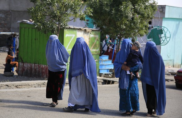 Afghan women walk on the road during the first day of Eid al-Fitr in Kabul, Afghanistan, Thursday, May 13, 2021. Eid al-Fitr prayer marks the end of the holy fasting month of Ramadan in Afghanistan. ( ...