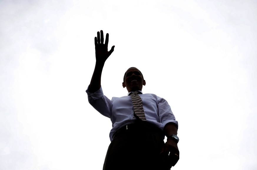 President Barack Obama is seen silhouetted on stage waving to supporters at a campaign event at the Living History Farms, Saturday, Sept. 1, 2012, in Urbandale, Iowa. (AP Photo/Pablo Martinez Monsivai ...