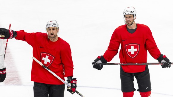 Switzerland's Nino Niederreiter, left, gestures next to Switzerland's Roman Josi, right, during a training session of team Switzerland at the 2026 Olympic Winter Games in Milan Santa Giulia  ...