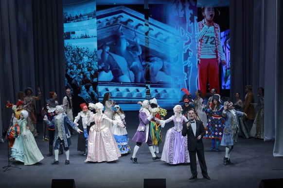 Actors perform on the stage of the Mariupol Drama Theatre re-opened its doors for the first time in more than three years, after it was badly damaged during fighting between Russian and Ukrainian forc ...