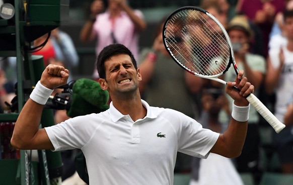 epa06876599 Novak Djokovic of Serbia celebrates his win over Karen Khachanov of Russia in their fourth round match during the Wimbledon Championships at the All England Lawn Tennis Club, in London, Br ...