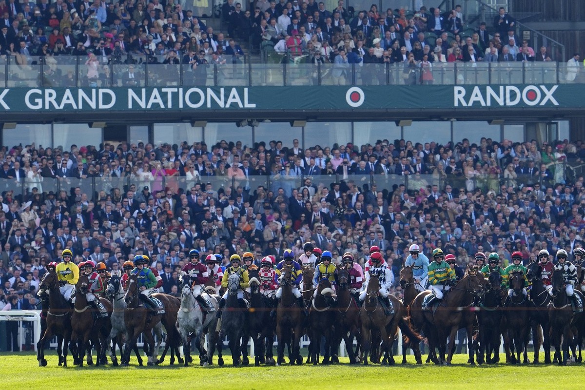 Horses start into the Grand National horse race at Aintree Racecourse Liverpool, England, Saturday, April 15, 2023. The iconic Grand National race which is run over fences is 4 miles, 2 � furlongs has ...