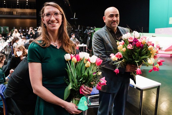 epa09716783 Newly elected Federal Managing Director of the federal Green party (Die Gruenen) Emily Buening (L) and newly elected party co-chair Omid Nouripour pose for photographer with flowers during ...