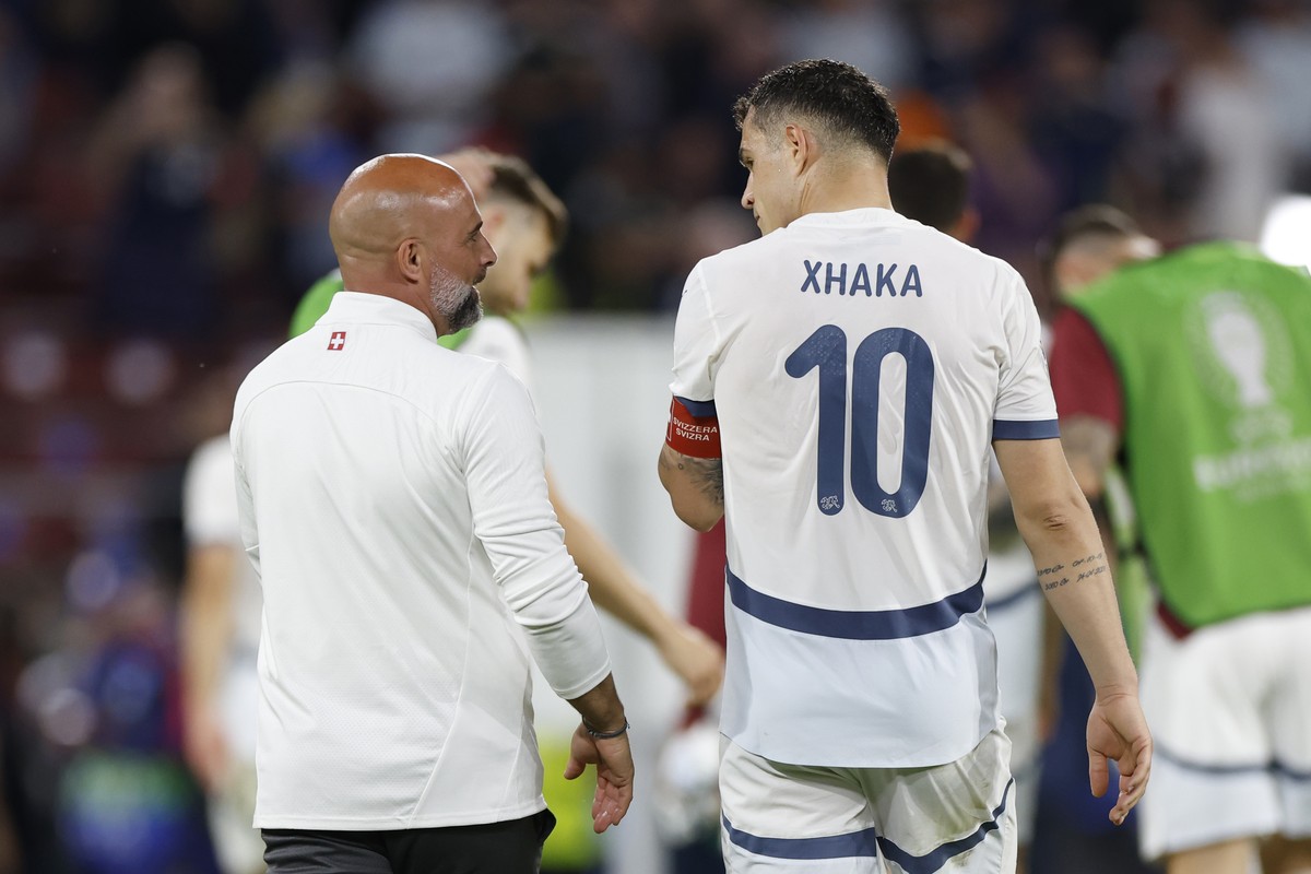 Switzerland's Granit Xhaka, right, talks to assistant coach Giorgio Contini after the draw (1-1) during a Group A match between Scotland and Switzerland at the Euro 2024 soccer tournament in Colo ...